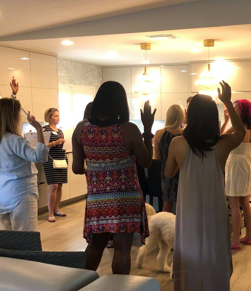 group photo retreat discussion with hands raised